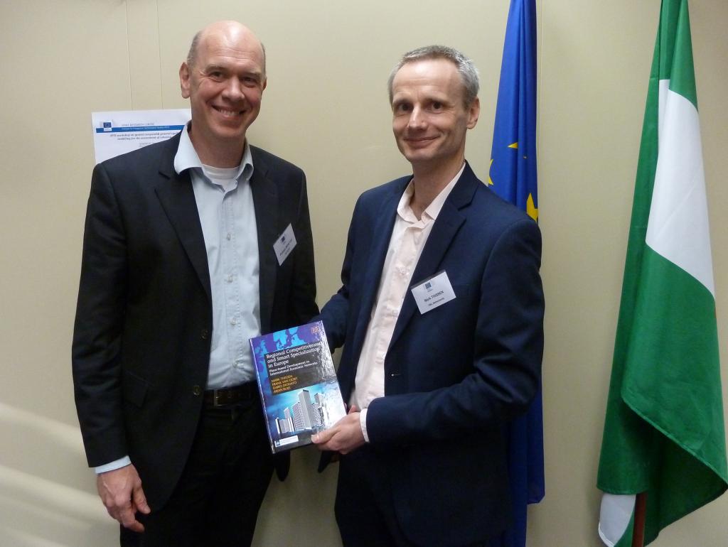 Mark Thissen of the PBL distributes the first copy to Philippe Monfort of the European Commission